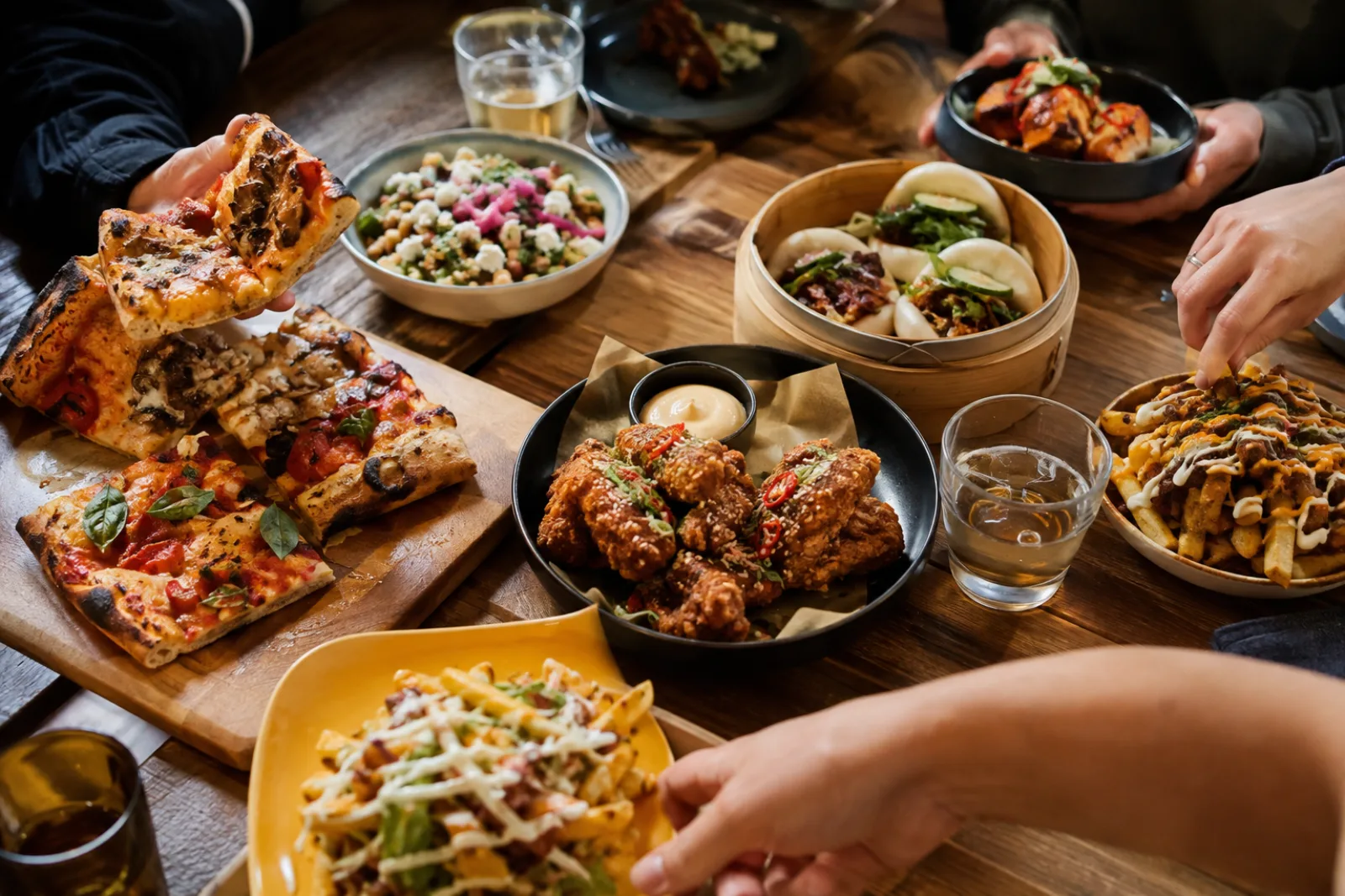 A shared table filled with varied street food dishes